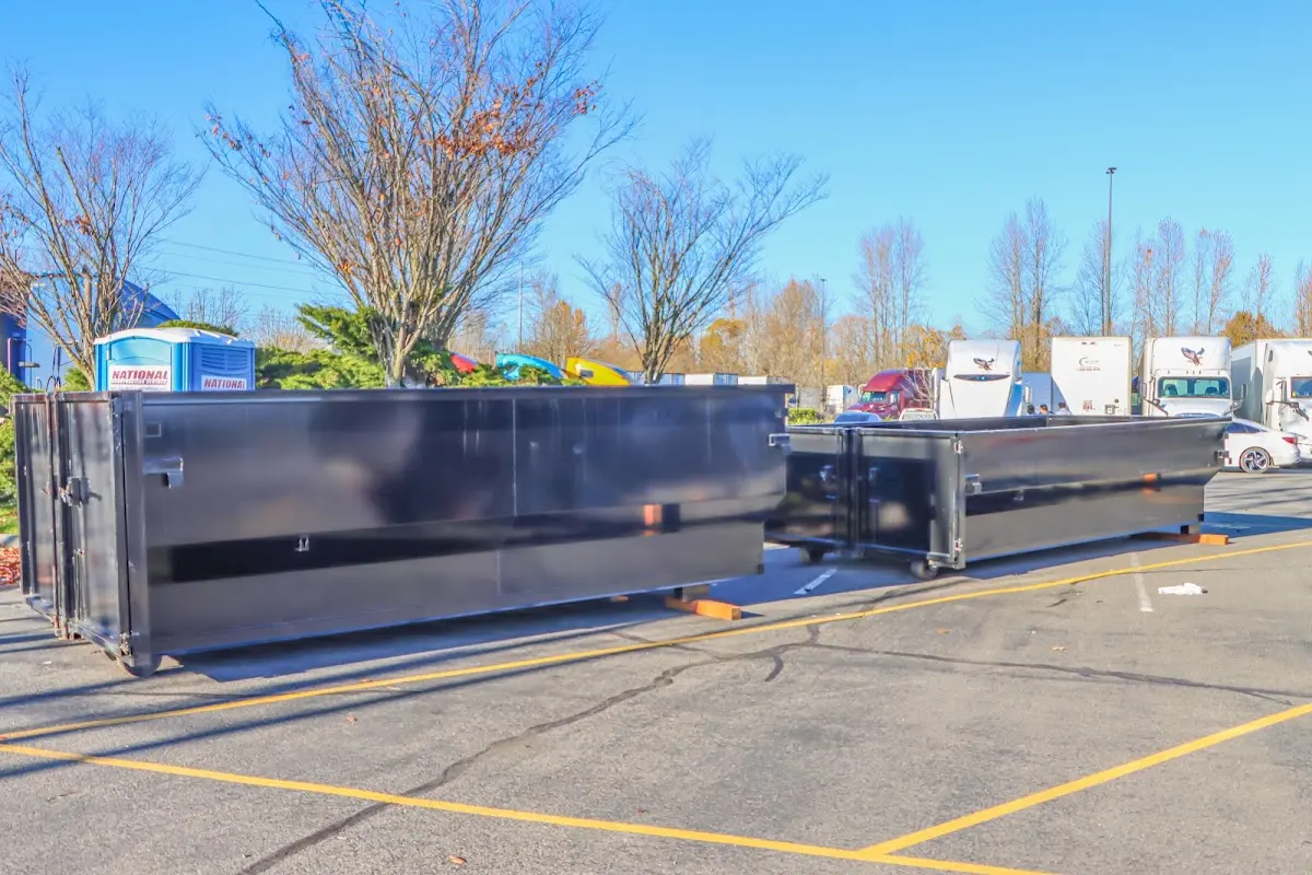 Professional dumpster rental service with roll-off container on residential driveway in Cedar Hills